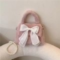 Pink plush handbag featuring a large white silk bow and elegant pearl chain detail - Pink