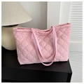 Detail view of pink quilted tote bag with diamond pattern and leather shoulder straps - Pink