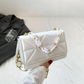 White quilted crossbody bag with acrylic chain handle and patterned wide strap - White