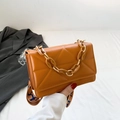 Bright orange crossbody bag with geometric embossing and stylish resin chain handle - Brown