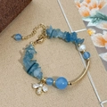 Blue crystal and freshwater pearl bracelet with gold bee charm on a textured background - Blue Natural Stone Freshwater Pearl Bee Pendant Style