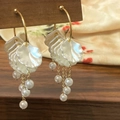 Detail of gold C-shaped earrings with pearl flower fringe and elegant tassels - Petal Tassel Style (A-425) / Gold
