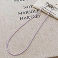 Vintage light purple pearl necklace with silver lobster clasp on a beige linen background - Taro Purple Pearl (3mm)