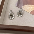 Detailed view of silver layered hoop earrings with a modern intertwined metal design - Silver