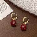 Detail of square red enamel charms on golden hoop earrings set on cozy knit fabric - Red Small Square (A-928) / Ancorra Red