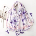 Floral print long scarf with purple tassels on a white background with props - Blue and Purple