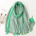 Close-up of lightweight green floral cotton linen scarf with elegant fringe details - Green