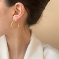 Chic twisted gold-plated hoop earrings with woven texture on model side view - Gold Smooth Hoop