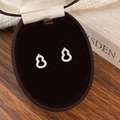 Macro shot of silver gourd stud earrings with pave zircon in a velvet jewelry box - Silver