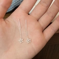 Close-up of sparkling silver snowflake threader earrings with central zircon on palm - Silver Short Ear Threaders / Silver