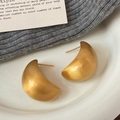 Macro shot of geometric teardrop earrings with a matte brushed gold finish on ceramic - Brushed Gold