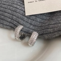 Detail view of silver micro-pave hoop earrings with three rows of shimmering zircons - Silver