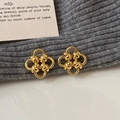 Polished gold four-leaf flower stud earrings with elegant woven metal knot design - Gold