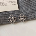 Elegant silver four-leaf clover stud earrings with a polished twisted metal design - Silver
