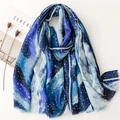 Blue and white gradient scarf with gold foil accents and fringe, displayed with props - Blue (SL2211-002)