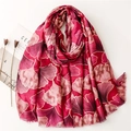 Detailed shot of red linen scarf with gold-edged ginkgo leaf pattern and fringe trim - Rose Red