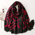 Detail of soft black scarf with magenta geometric pattern and fine fringed edges - Black with Red Letters