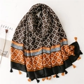 Ethnic geometric print scarf with tassels and fringe on a minimalist white background - Black