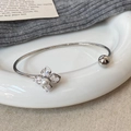 Elegant four-leaf flower open bangle with zircon, pearl details, and minimalist silver finish - Silver