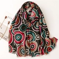 Detailed flat lay of a black shawl with colorful concentric circles and raw fringe edges - 180*85CM / Black