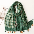 Green long scarf with abstract cashew patchwork and orange fringe on white background - Green
