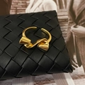 Minimalist gold bow-shaped open ring displayed on a black woven leather background - Twisted Bowknot Style (C-382-Gold) / Gold