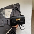 Elegant black trapezoid handbag with lychee pattern leather and gold metal lock detail - Black