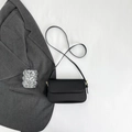 Gros plan d'un sac à bandoulière en cuir noir avec des détails dorés élégants - Noir