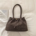 Dettaglio borsa tote in pelle scamosciata marrone scuro con fibbia dorata e manici sottili - senza ciondolo / Marrone scuro