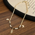 Detail of vintage bohemian necklace with shell butterflies and beaded pendant accents - Butterfly Leaf Pendant Beaded Style