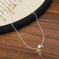 Collana di perline elegante con ciondolo a fiocco dorato e perla su sfondo vintage - Perla Bianca Catena di Perline Trasparenti / Oro