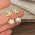 Detail of elegant butterfly earrings with champagne opal and baroque pearls on a warm background - Butterfly Pearl Style (White Ball Studs)