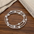 Elegant multi-layered silver pearl bracelet featuring three interwoven textured metal bands - Silver