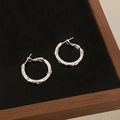 Detailed view of silver hoop earrings featuring a unique hammered metal texture finish - Shiny Silver Hammered Style (A-1375)