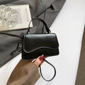Chic black mini crossbody bag with wavy flap design and elegant top handle leather texture - Black