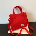 Minimalist bright red canvas tote bag with contrast label and adjustable shoulder strap - Red