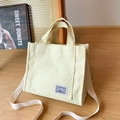 Cream canvas tote bag with adjustable shoulder strap and minimalist woven label - Beige