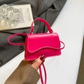 Rose pink mini PU leather handbag with wavy flap held by hand in a chic setup - Rose Red