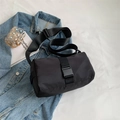 Minimalist black oxford crossbody bag with buckle closure in flat lay composition - Black