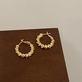 Detail of gold-plated hoop earrings with unique layered texture on wooden display - 3D Gold Flake Texture Style (A-1131)