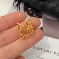 Macro detail of golden irregular lava texture ring with modern liquid metal finish - Gold