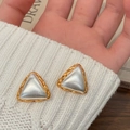 Macro shot of vintage triangle earrings with braided gold edges and silver pearlescent inlay - Brushed Two-tone Triangle