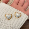 Detail of heart-shaped gold-plated earrings with mother-of-pearl inlay on white knitwear - Brushed Two-tone Heart