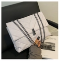 Close-up of lavender quilted leather shoulder bag with dark metal chain and twist lock - White