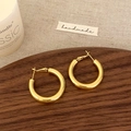 Elegant polished thick gold hoop earrings with mirror finish on rustic wood background - Gold 3cm Earrings