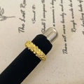 Close-up of golden braided texture ring with small zircon stones on vintage background - Cross Braided Texture Style (C-157)