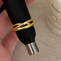 Detailed shot of gold-plated multi-layer crossover ring with hammered rock texture - Gold