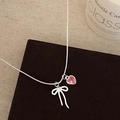 Detailed close-up of a silver bow and pink heart pendant on a delicate snake chain - Pink Heart Bow Necklace (B-580)