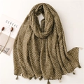 Detailed macro view of soft cotton linen scarf with floral pattern and fringe tassels - Army Green