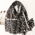 Detailed view of leopard print cotton scarf with fringe edge and geometric patchwork design - Gray